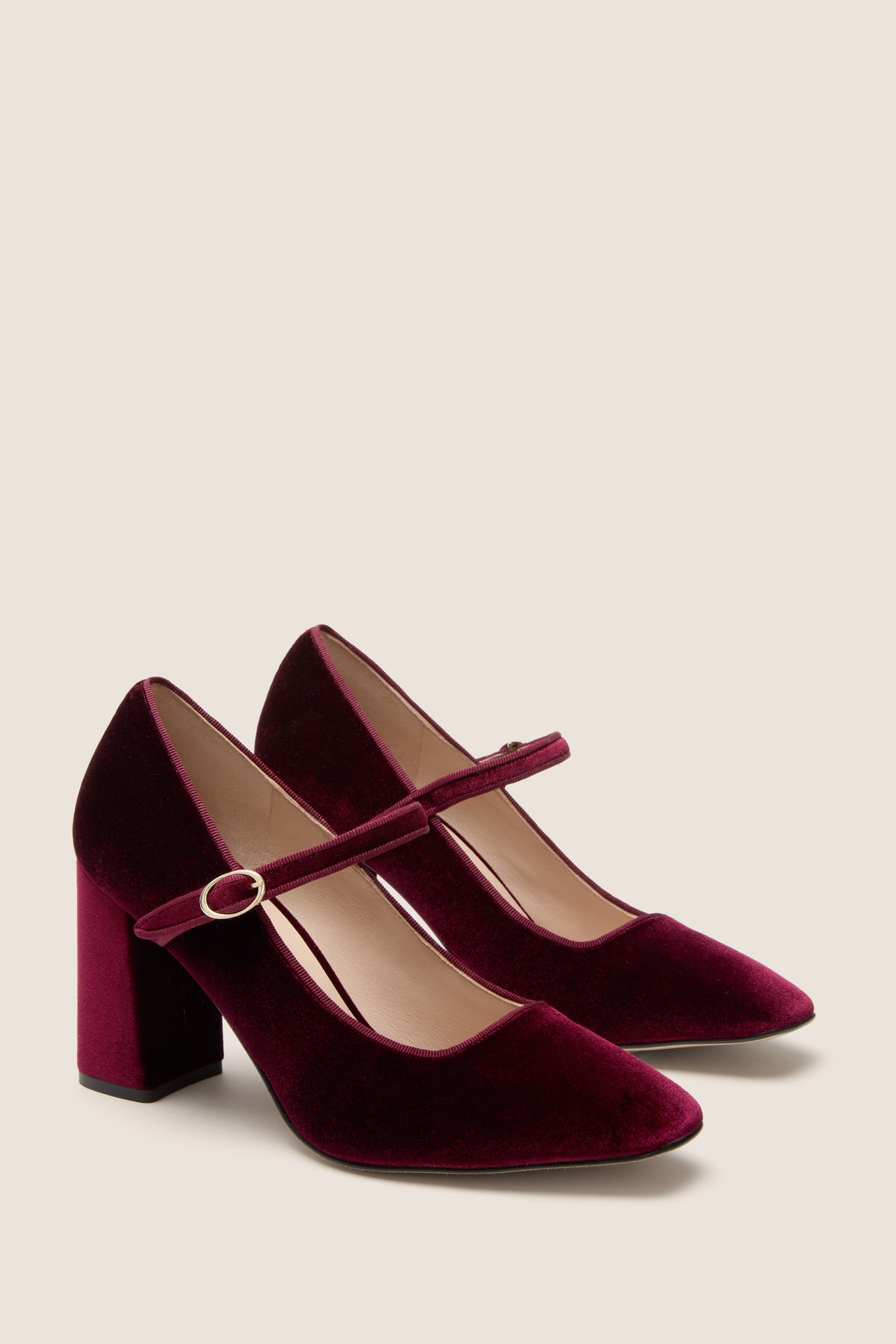 Oxblood Velvet Julia Heels: Classic Mary-Jane pumps in wine velvet with a round toe, adjustable gold buckle strap, and chunky block heel for an effortless, high-end look.