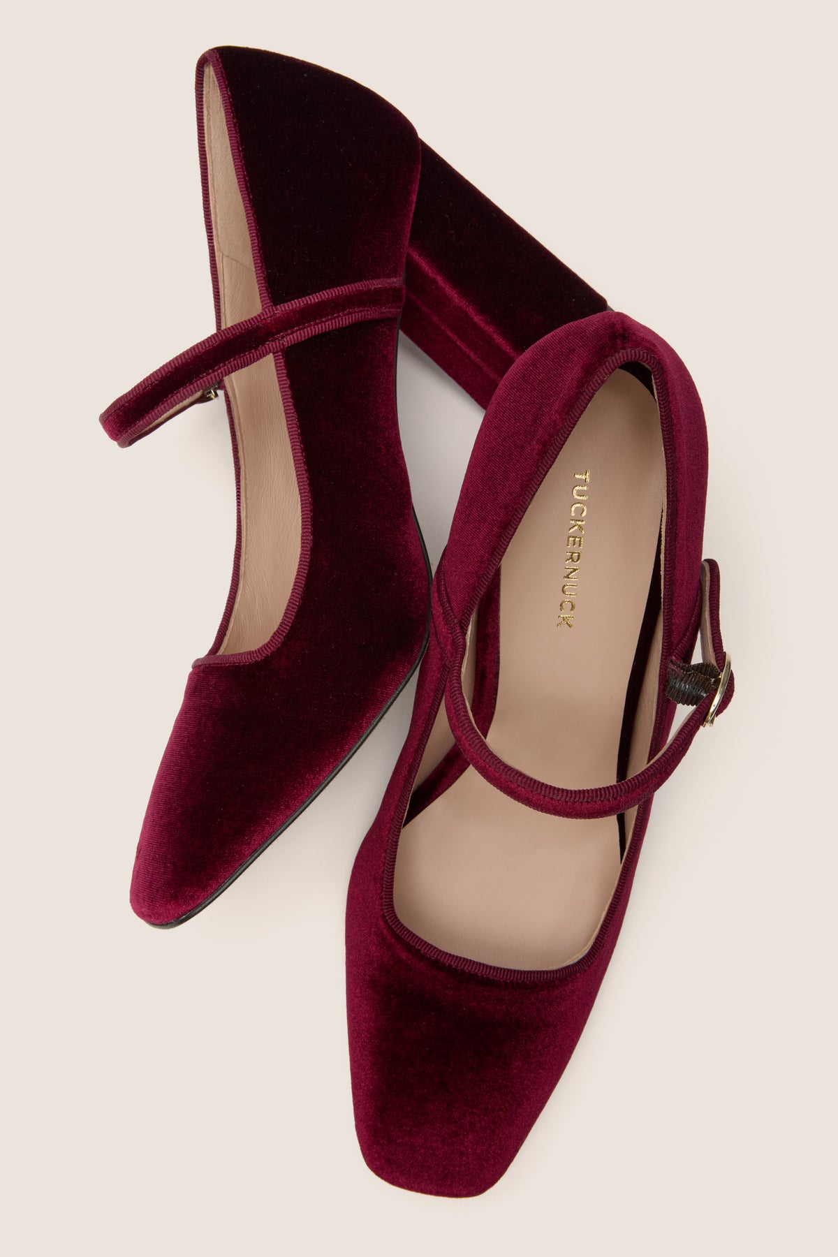 Oxblood Velvet Julia Heels: classic Mary-Jane style with an effortless block heel and adjustable gold arch strap, exuding high-end elegance and fun versatility for any occasion.