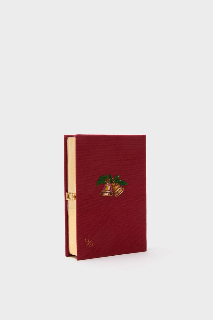Camelia Holly Jingle and Mingle Book Clutch: A classic, high-end, book-shaped case with gold latch, embroidered bells, limited edition 10 / 77, and shiny gold interior.
