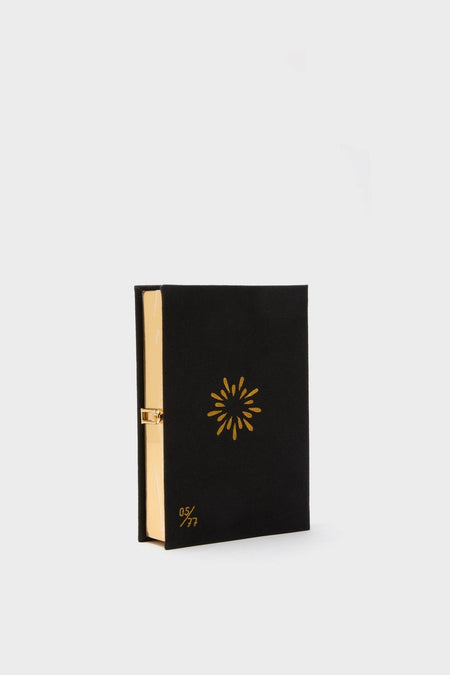 Black Starry Night Spectacular Book Clutch, a classic, high-end decorative box resembling a book, with gold embroidery and clasp, embodying effortless fun and sophistication.