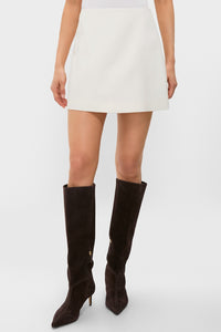Cream Wool Meg Mini Skirt, classic and high-end, styled with suede knee-high boots. Effortless A-line silhouette, perfect for a fun, versatile wardrobe addition.