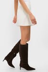 Cream Wool Meg Mini Skirt styled with classic dark brown knee-high suede boots, showcasing an effortlessly chic A-line silhouette and fun, high-end transitional fashion.