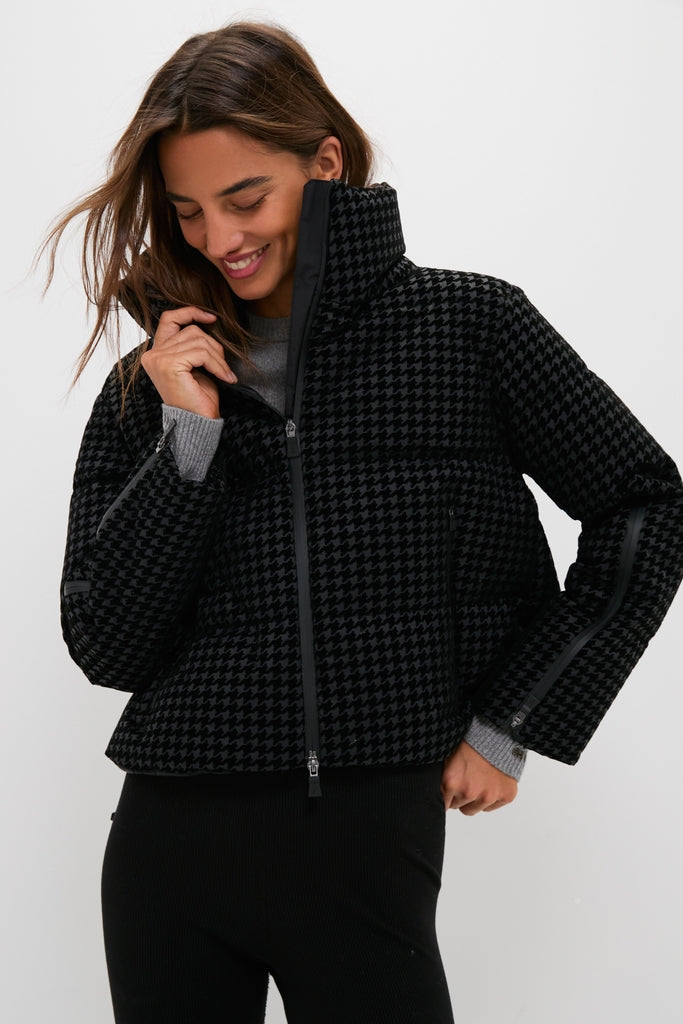 Young woman models the classic Black Tech Pied de Poule Short Jacket, highlighting its effortless, high-end design with a chic houndstooth pattern and functional features.