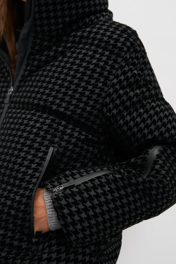 Black Tech Pied de Poule Short Jacket in subtle houndstooth, showcasing classic quilted padding, zipped pockets, light gray cuffs, and effortless high-end design for fun, versatile wear.