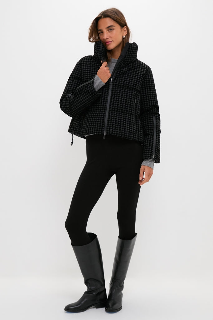 Model in a classic, high-end Black Tech Pied de Poule Short Jacket with a houndstooth pattern, showcasing effortless style with feather padding and functional zippers.