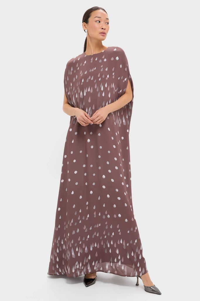 Model wearing the classic Polka Rain Eleonore Dress, featuring an effortless, floor-length silhouette with playful raindrop pattern, embodying high-end, fun elegance.