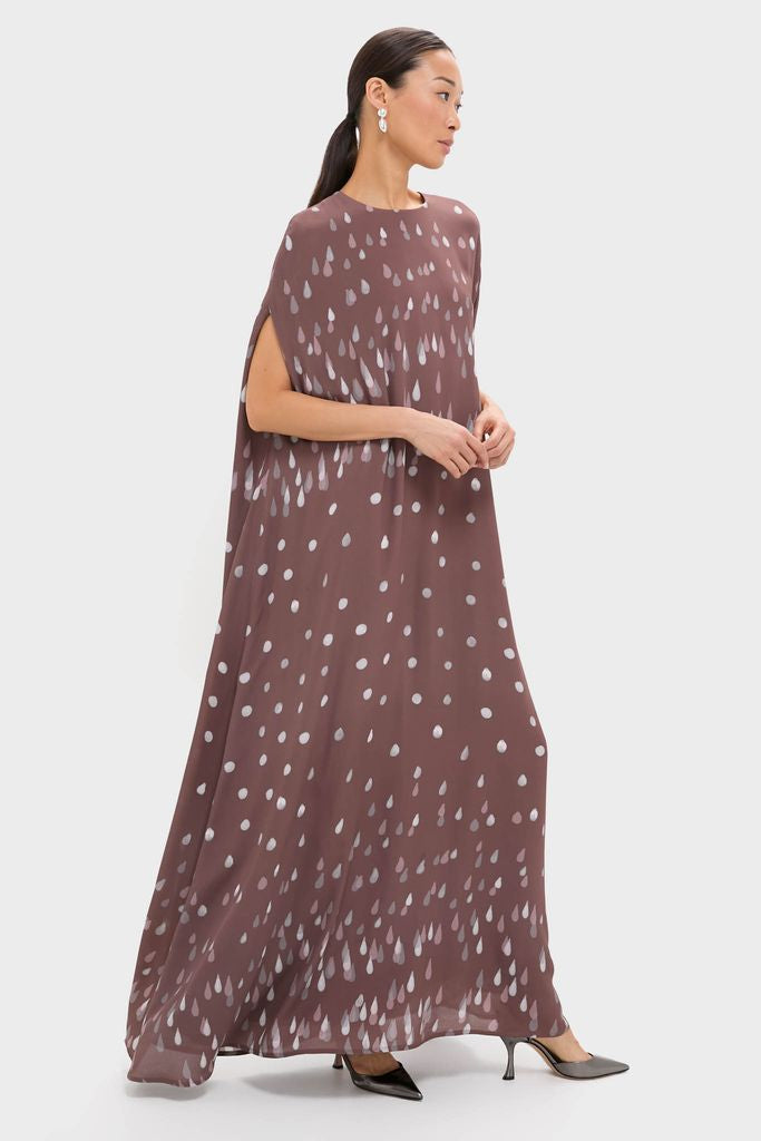 Polka Rain Eleonore Dress: A classic, effortless maxi with cape sleeves and playful raindrop print, styled with black pumps for a high-end, fun look.