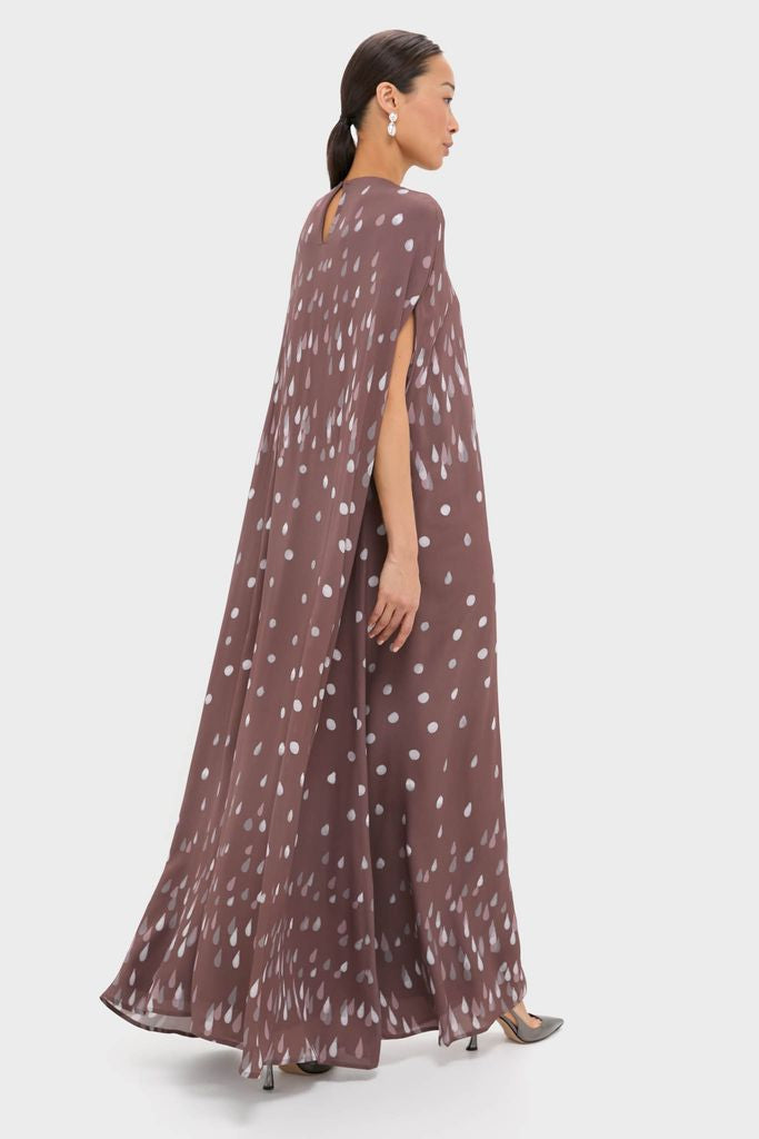 Model wearing Polka Rain Eleonore Dress: a classic, high-end, floor-length gown with an effortless, fun silhouette, cape-like sleeves, and teardrop motifs, ideal for elegant events.