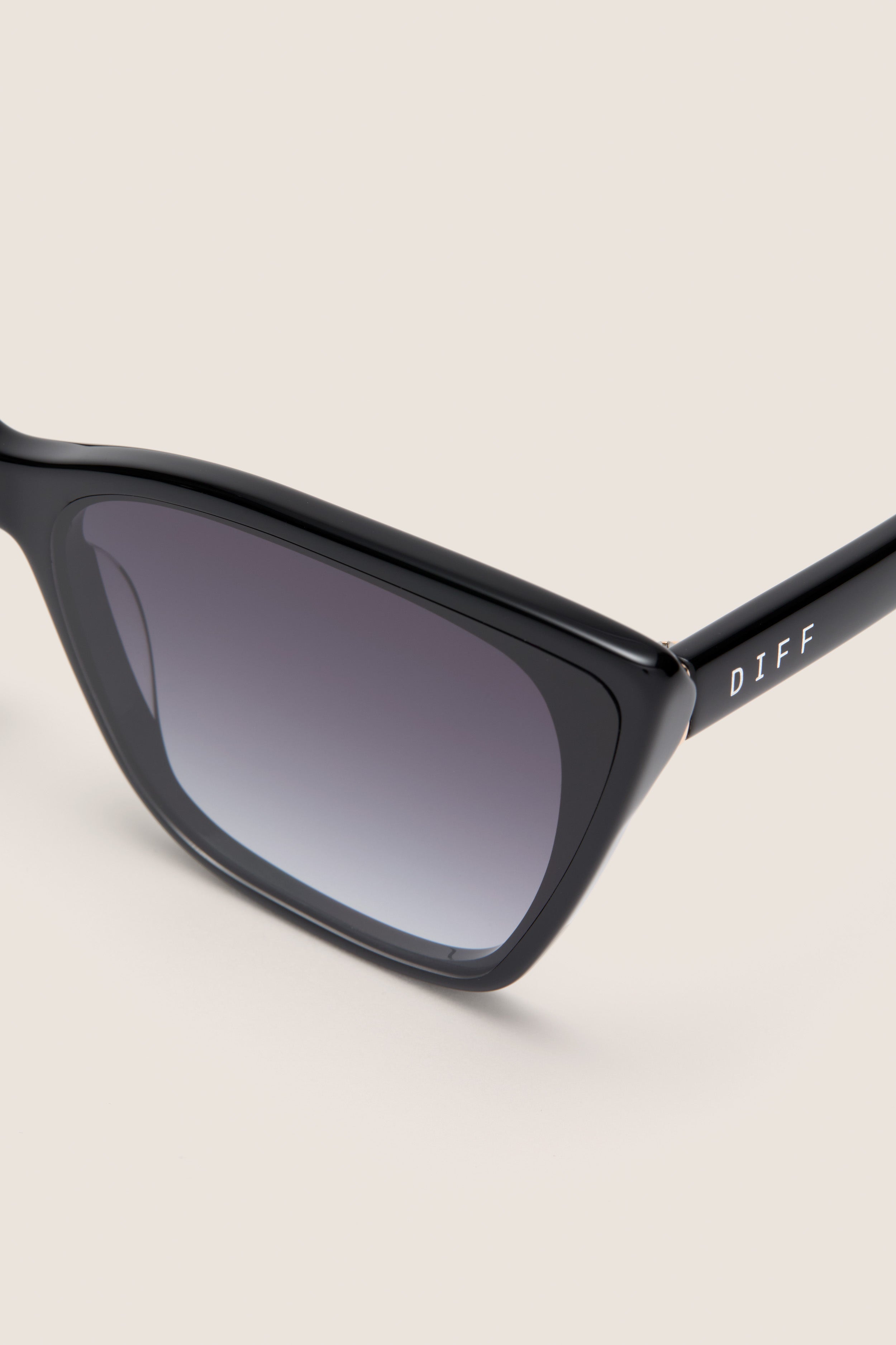 Black Alina Sunglasses: Classic cat-eye design with gradient lenses, effortlessly blending vintage flair and high-end style for a fun, confident look.