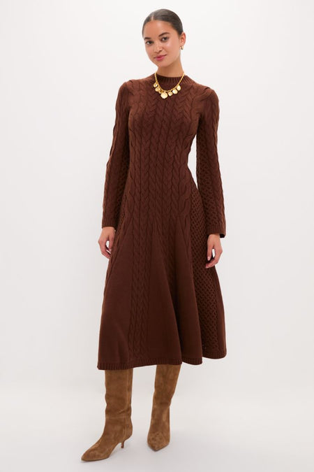 Model wearing the classic Chocolate Cable Knit Fernie Midi Dress, paired with a chunky gold necklace and tan knee-high boots, reflecting effortless, high-end style.