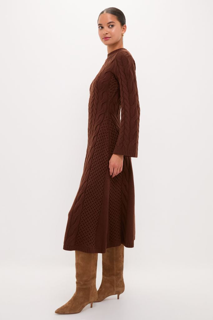 Model wearing the classic Chocolate Cable Knit Fernie Midi Dress with an effortless flared hem, paired with high-end tan suede knee-high boots, embodying fun sophistication.