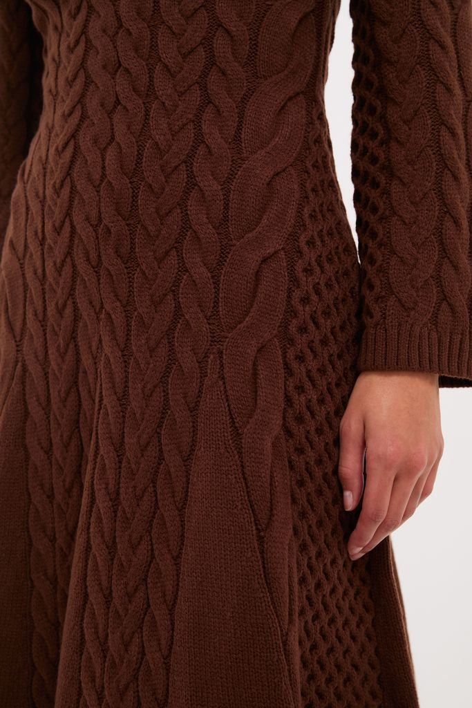 Close-up of the Chocolate Cable Knit Fernie Midi Dress, showcasing its classic cable and honeycomb knit patterns with an effortless, high-end style. Perfect for fun, confident wear.