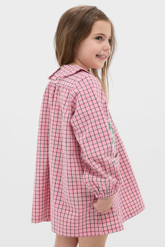 Girl in Pink Check Gatsby Dress with embroidered daisies, ruffled collar, and elasticized cuffs, embodying classic, effortless charm and fun style from high-end brand Hello Simone.