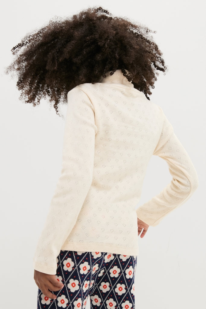 Bebe Heart Turtleneck: Classic, effortless style with a fun, high-end pointelle design featuring heart motifs, perfect for relaxed days.