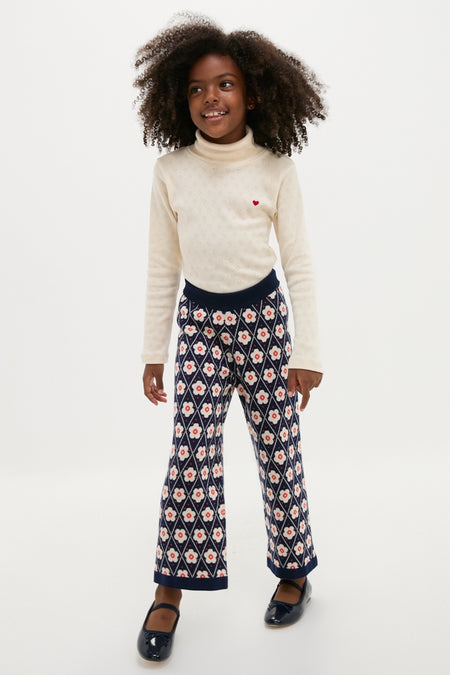 Young girl in Bebe Heart Turtleneck, showcasing a classic, effortless style with high-end organic cotton, perfect for fun and comfort during the fall season.
