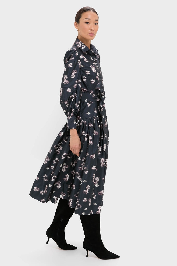 Lebombo Black Nora Midi Dress: A classic, effortless silhouette with a fitted bodice, voluminous sleeves, and playful floral print, styled with chic black knee-high boots.
