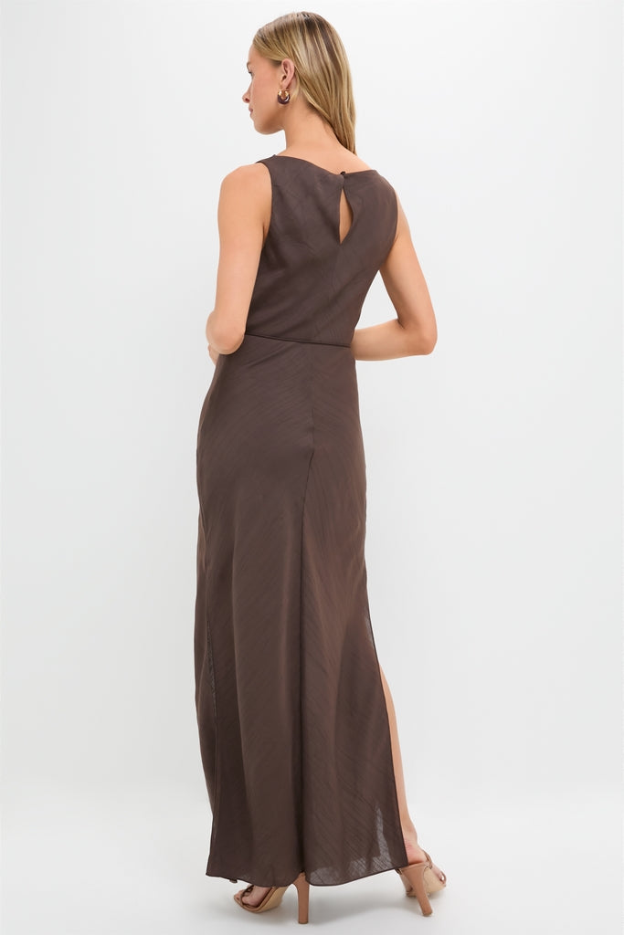 Model in a classic Chocolate Serine Maxi Dress with a keyhole back, side slit, gold hoop earrings, and nude strappy heels, embodying effortless, high-end style.