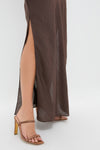 Chocolate Serine Maxi Dress featuring a high side slit, styled with light brown, open-toe strappy sandals. A classic, effortless look exuding fun and high-end elegance.