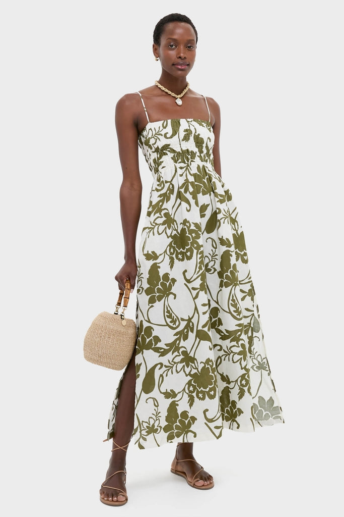 Dahlia Maxi Dress: An effortless, classic summer look featuring a smocked bodice, side slit, and pockets, paired with chic sandals and a fun straw bag.