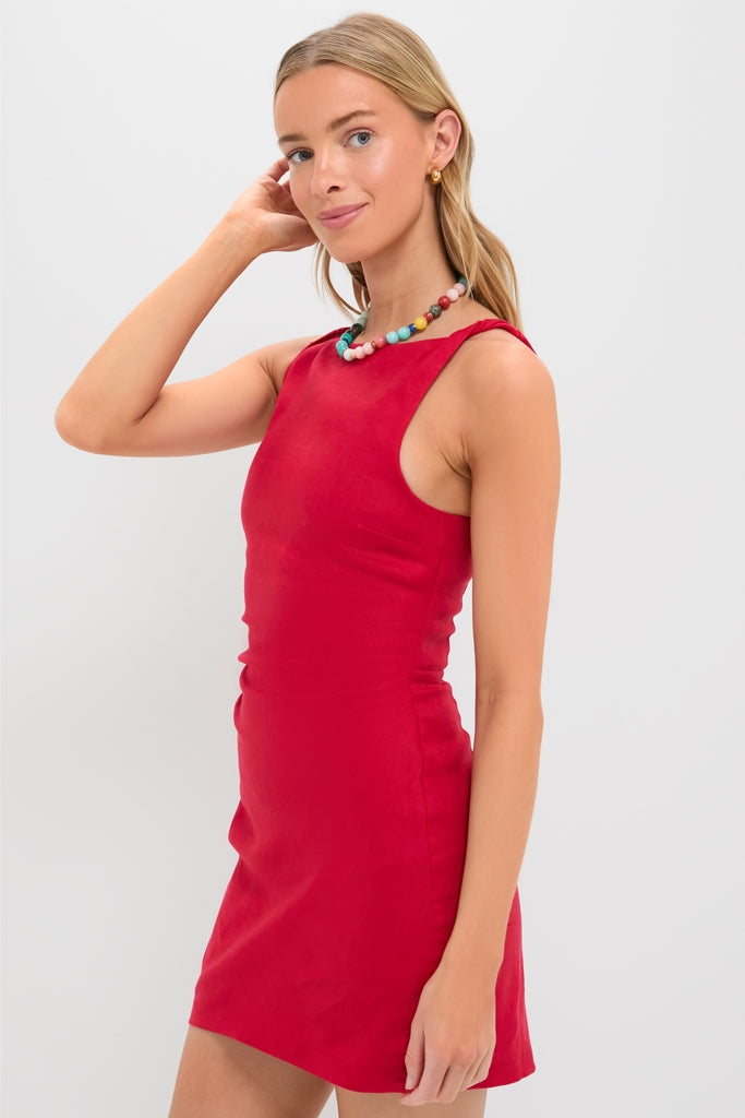 Young woman in a classic, high-end, sleeveless Vermillion Lotta Mini Dress, exuding effortless style with a fun, multicolored beaded necklace, embodying Tuckernuck's cool confidence.