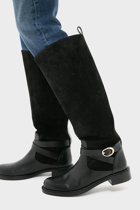 Black Benni Riding Boots featuring a classic leather and suede design with a gold-tone buckle, styled effortlessly over jeans for a high-end, fun, and timeless look.