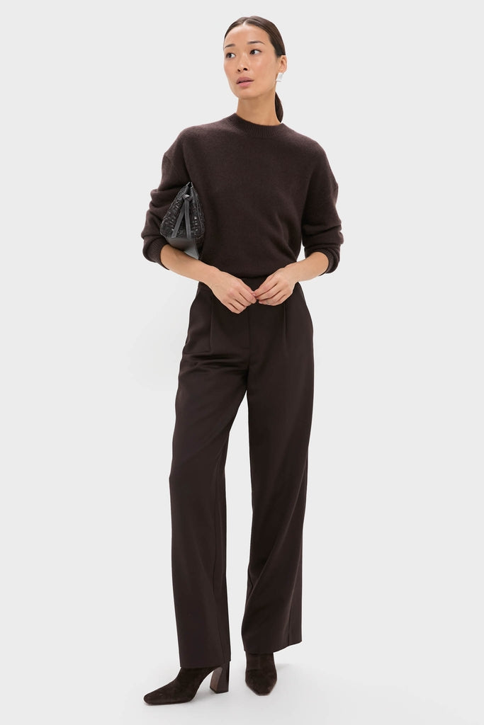 Woman in brown outfit, subtly showcasing classic, silver ribbed earrings. These high-end studs add an effortless, fun polish to her sophisticated look.