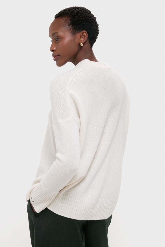 Model wearing the Ivory Cashmere Cassie V-Neck Sweater, featuring a classic, effortless design with ribbed finishes, perfect for high-end, fun styling with versatility.