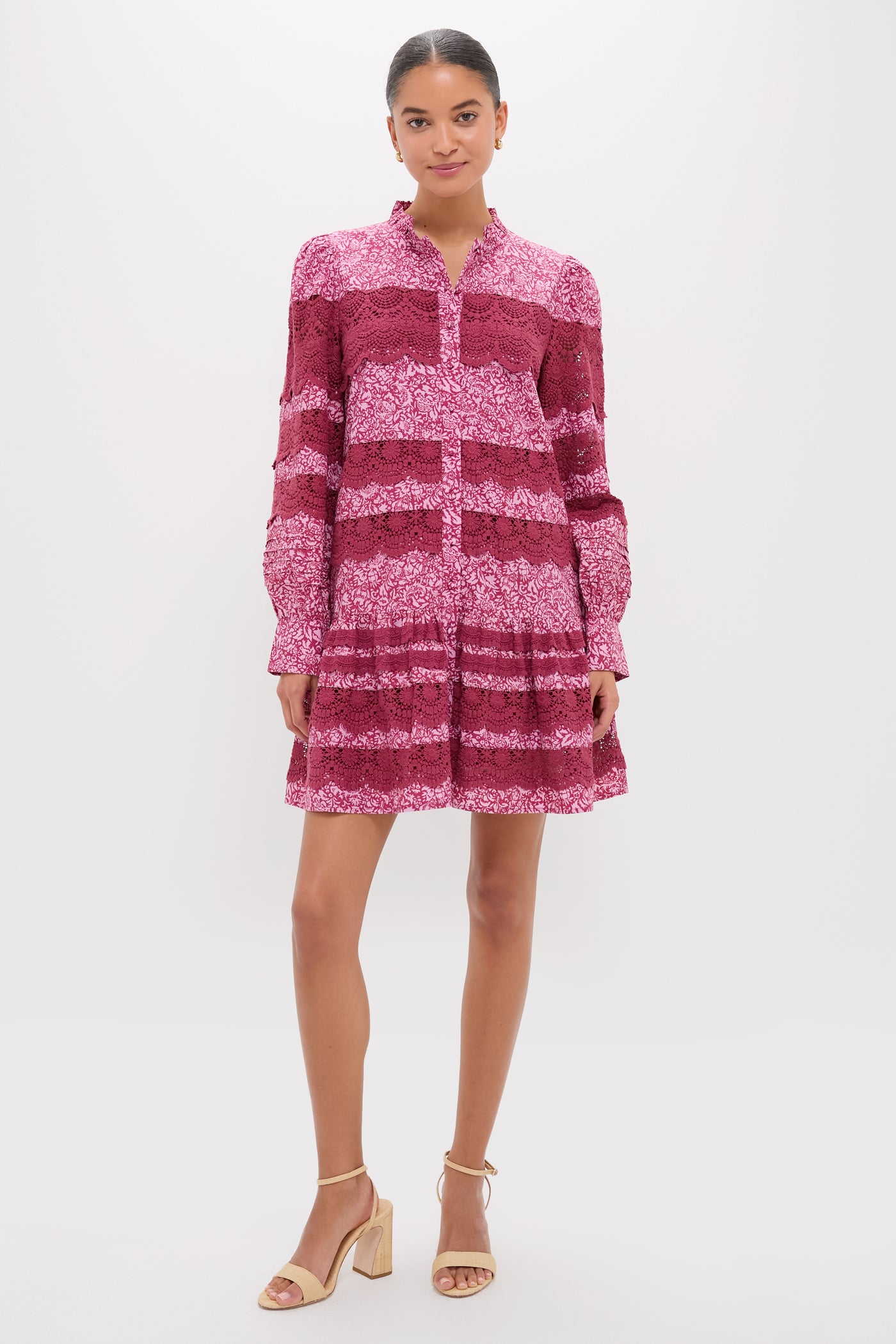 Woman in Lace Trim Maroon & Pink Floral Emmie Mini Dress with ruffle collar and blouson sleeves, paired with beige sandals. Classic, effortless, and fun high-end style.