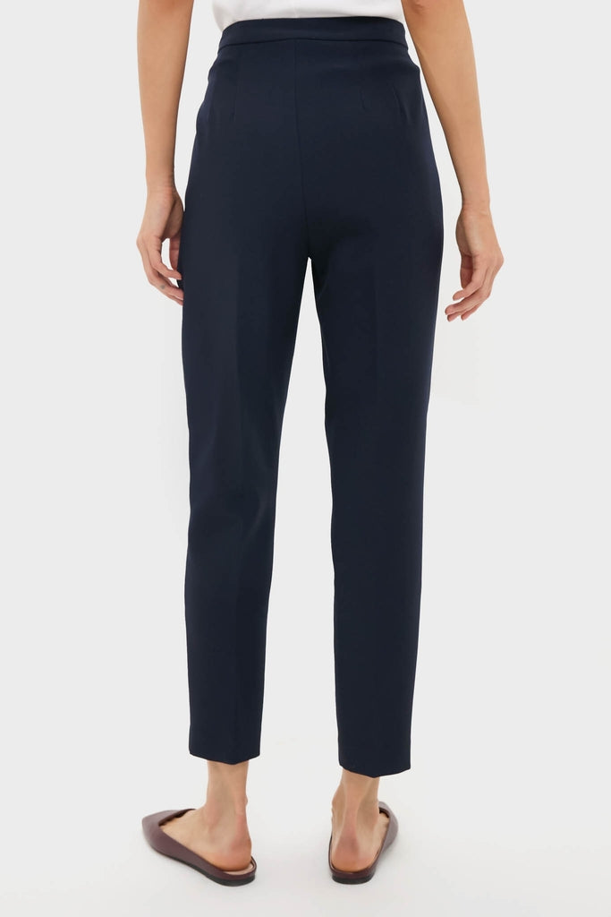 Back view of the classic Navy Audrey Pants, effortlessly styled with brown sandals and a white top, showcasing a high-end, fun, and slimming design.