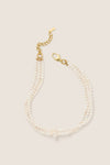White Freshwater Pearl Dalia Necklace: A classic, effortless multi-strand design with hand-strung pearls and a gold-tone clasp, embodying fun, high-end elegance.