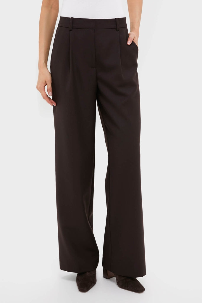 Woman wearing the classic, high-end Deep Brown Trent Trouser, featuring a wide-leg, relaxed fit and side pockets, paired with pointed-toe ankle boots for an effortless, fun look.