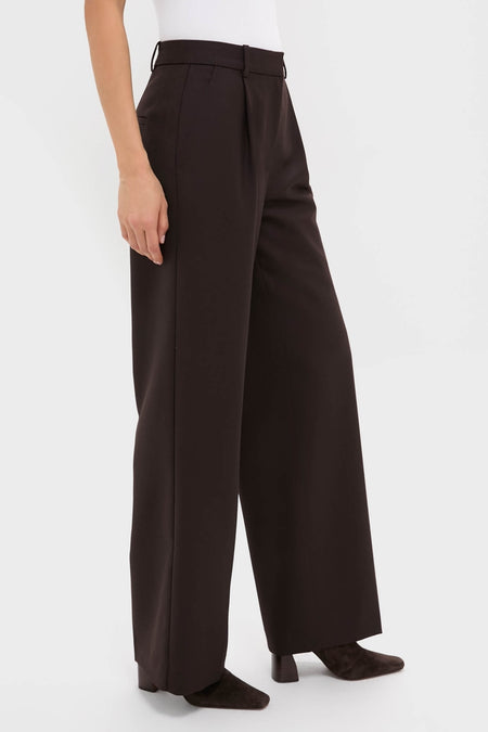 Model showcasing the classic Deep Brown Trent Trouser with a relaxed leg and front pleats, paired with dark heeled ankle boots for an effortless, high-end look.