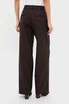 Model wearing classic Deep Brown Trent Trouser, high-waisted with relaxed legs, belt loops, and welt back pockets; effortlessly stylish and versatile for a fun, high-end look.