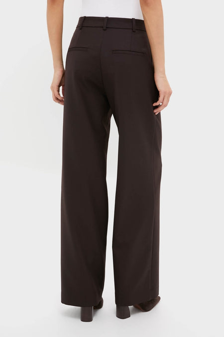 Model wearing classic Deep Brown Trent Trouser, high-waisted with relaxed legs, belt loops, and welt back pockets; effortlessly stylish and versatile for a fun, high-end look.