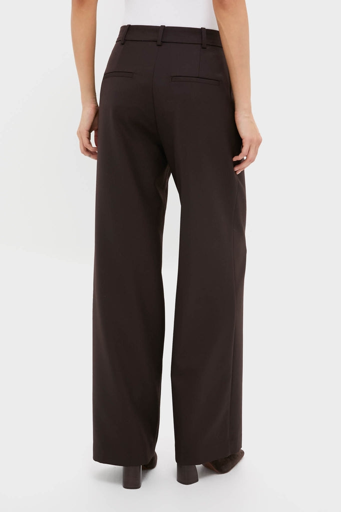 Model wearing classic Deep Brown Trent Trouser, high-waisted with relaxed legs, belt loops, and welt back pockets; effortlessly stylish and versatile for a fun, high-end look.