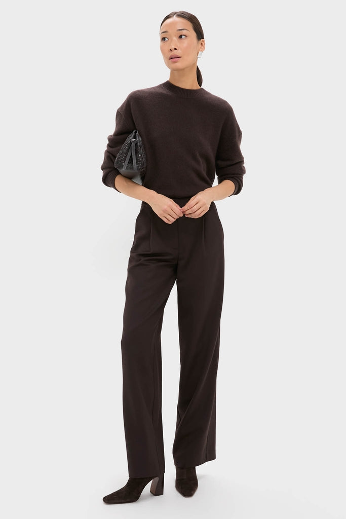 Model wearing classic Deep Brown Trent Trouser with relaxed leg and front pleats, paired with a knit sweater and suede ankle-booties for an effortless, high-end look.