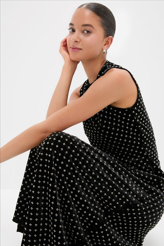 Young woman in a classic, effortless Black Embellished Velvet Antonia Midi Dress with floral pattern, embodying high-end, fun style.