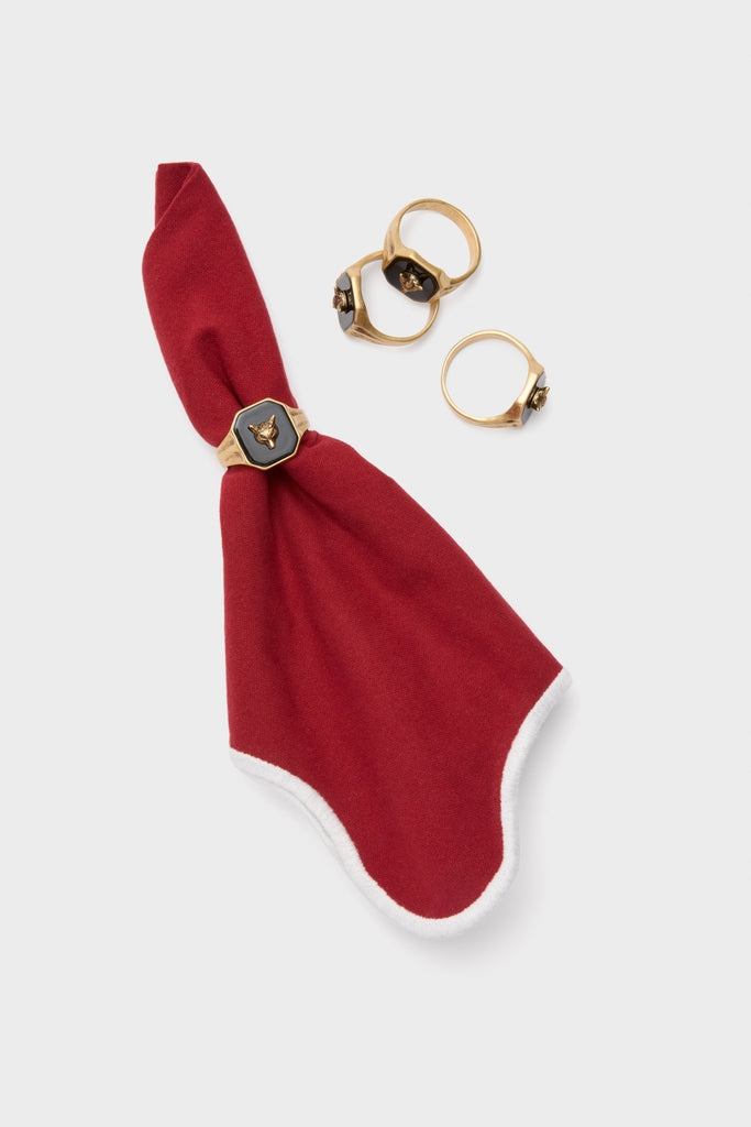 Cranberry and White Scalloped Napkins Set of 4 features a classic red napkin with white trim, accented by fun, high-end gold-tone napkin rings with animal-head motifs.