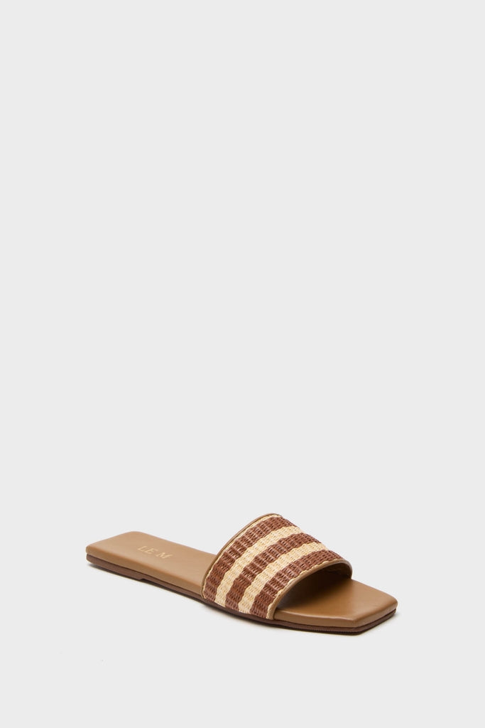 Honey Piper Sandals: Classic slide with flat tan sole and woven beige-brown strap, offering an effortless, fun style. Perfect for high-end, adventurous summer outings.