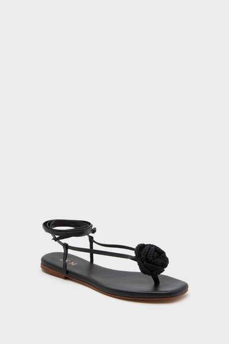 Black Flor Rose Wrap Sandals: classic and effortless women's flat sandal featuring a thong design with ankle straps and a knotted rope-style flower detail, perfect for high-end, fun fashion.