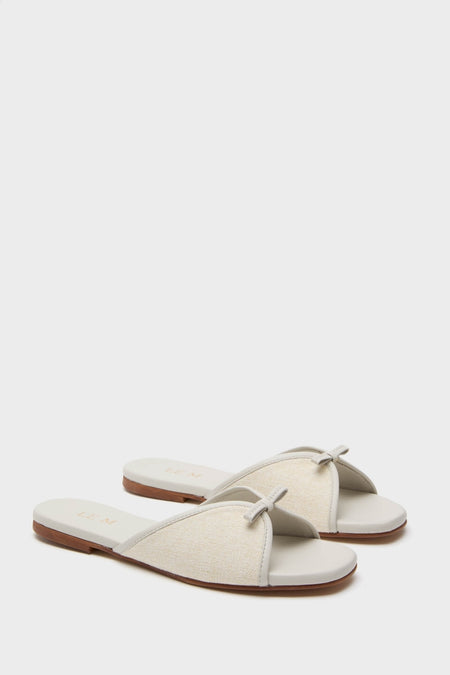 Off White Gianna Flat Sandals, featuring effortless slide-on style and classic knot detail, offer a fun yet high-end feel with cushioned comfort for beach walks.