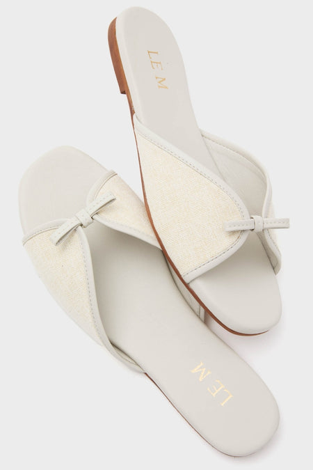 Off White Gianna Flat Sandals featuring a classic, effortless design with a woven knot detail on a wide strap, perfect for fun, high-end beach strolls.