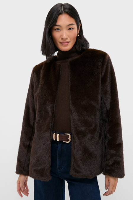 Woman modeling the classic Dark Brown Cassidy Faux Fur Jacket over a turtleneck sweater, epitomizing effortless style with high-end details like front closures and lined construction.