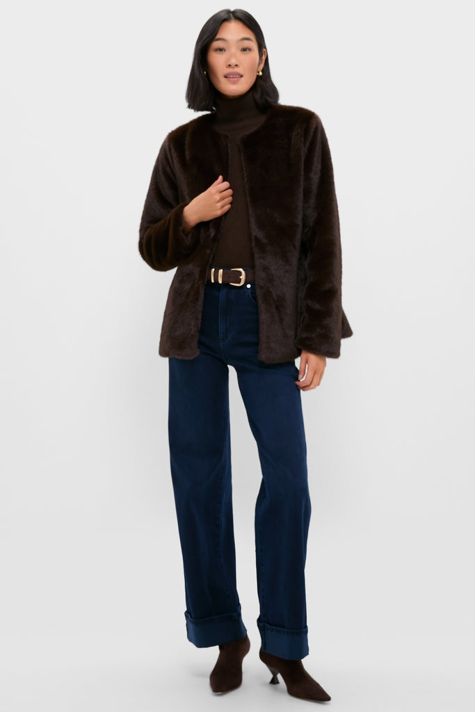 Model wears the classic Dark Brown Cassidy Faux Fur Jacket, effortlessly styled open over a turtleneck and jeans, embodying a fun, high-end winter look.