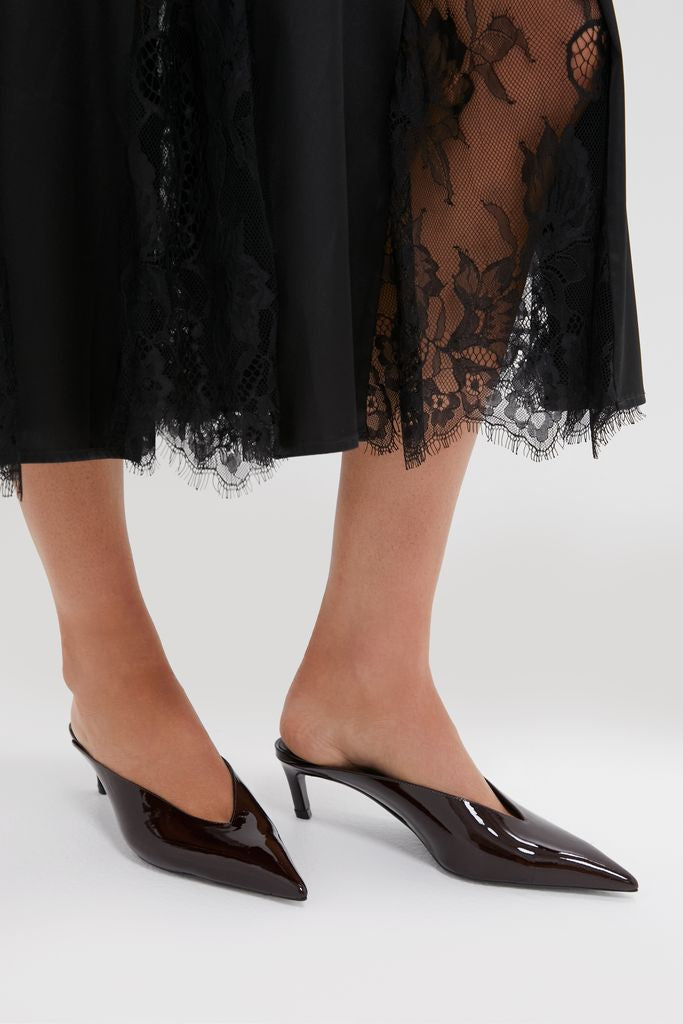 Classic Maplewood Loren Mid Heels in glossy patent leather, featuring a pointed-toe mule design with a kitten heel, exuding effortless, high-end style and fun sophistication.