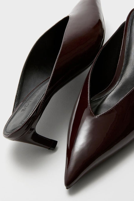 Maplewood Loren Mid Heels in glossy patent leather offer a classic, effortless style with pointed toes and slender heels, perfect for a fun, high-end look.