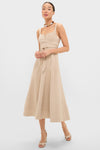 Woman in a classic, effortless Dune Suede Kendra Maxi Dress, featuring a square neckline, fitted bodice, and flared skirt, paired with fun, high-end accessories.