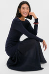 Young woman in a classic, effortlessly stylish Navy Gemma Mix-Media Dress, featuring a fitted bodice and sheer skirt, embodying a fun and high-end look.