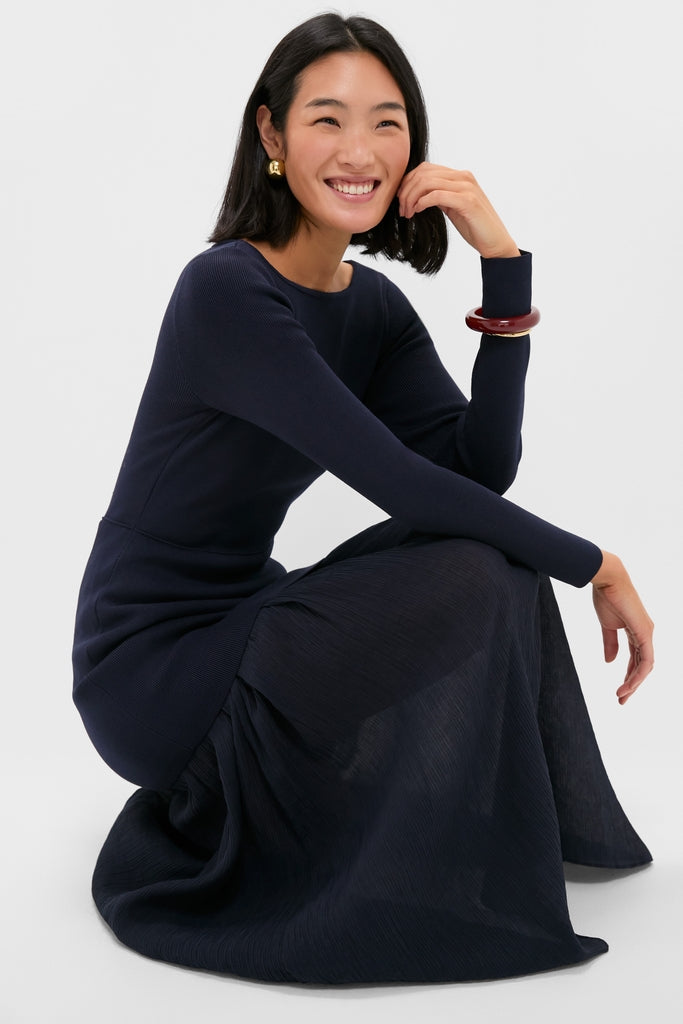 Young woman in a classic, effortlessly stylish Navy Gemma Mix-Media Dress, featuring a fitted bodice and sheer skirt, embodying a fun and high-end look.