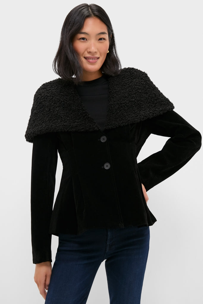 Young woman models the classic Black Geneva Jacket with a faux-shearling collar, exuding effortless, high-end style. Perfect for a fun, versatile look.